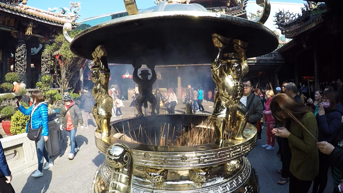 pray with incense at temple in Taiwan