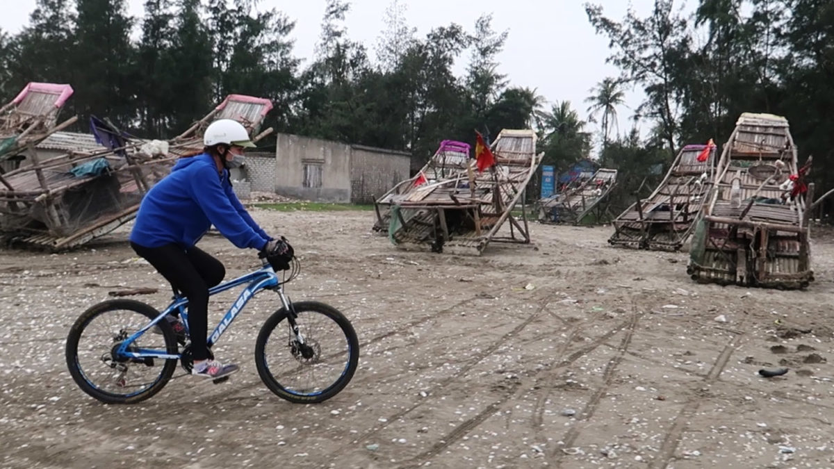 cycling vietnam ocean beach fishing boats