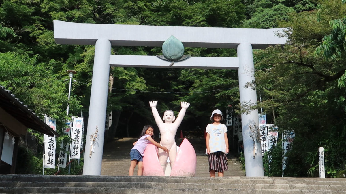 touching giant naked momotaro statue